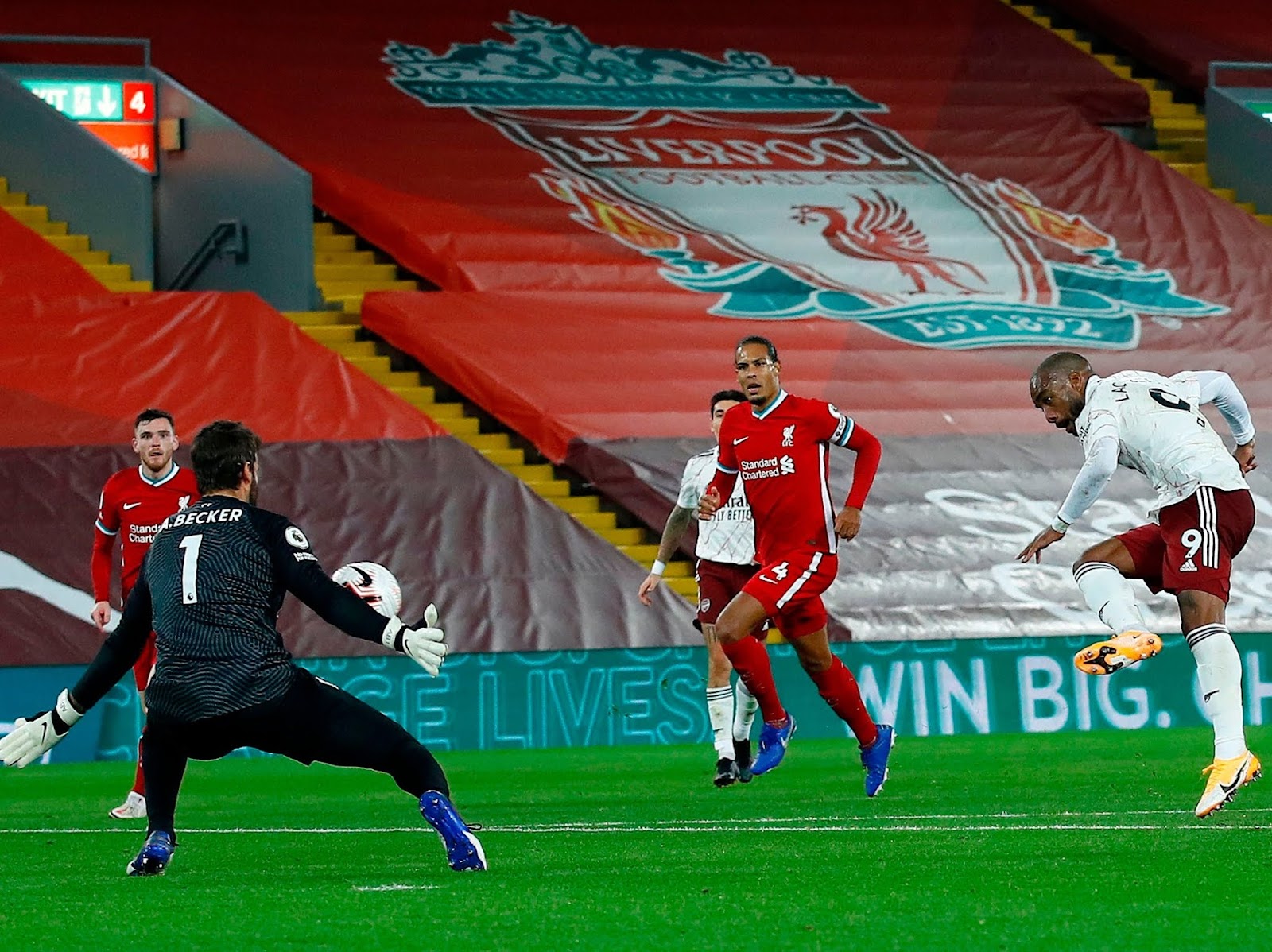 Alexandre Lacazette scoring against Liverpool at Anfield