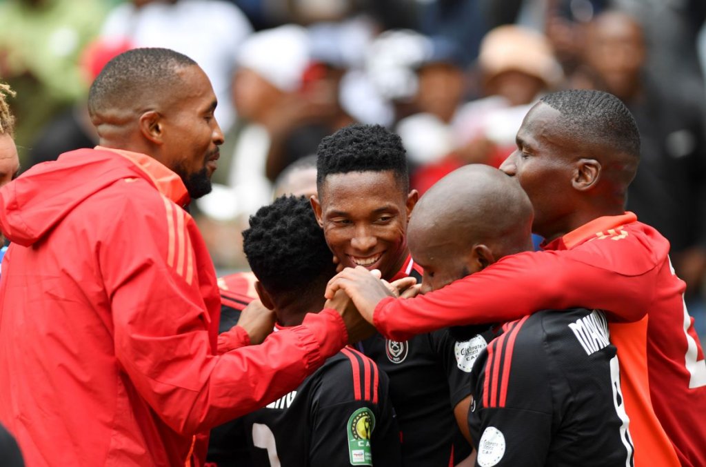 Thalente Mbatha of Orlando Pirates celebrates with teammates in CAF Champions League.
