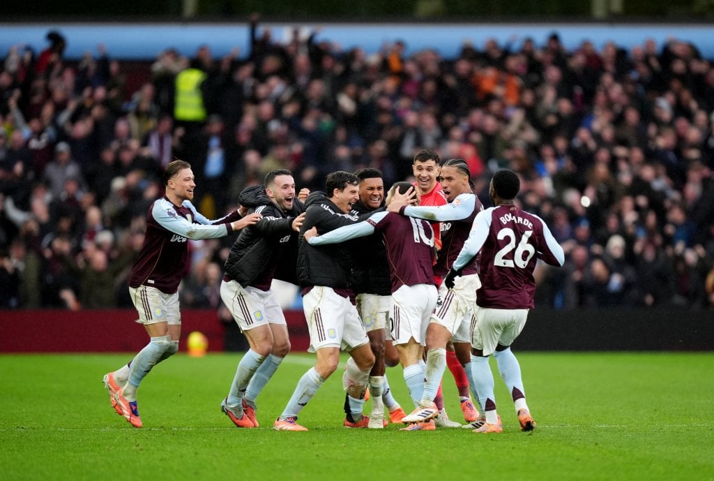 Aston Villa's Emi Buendia (fourth right) is mobbed by his team