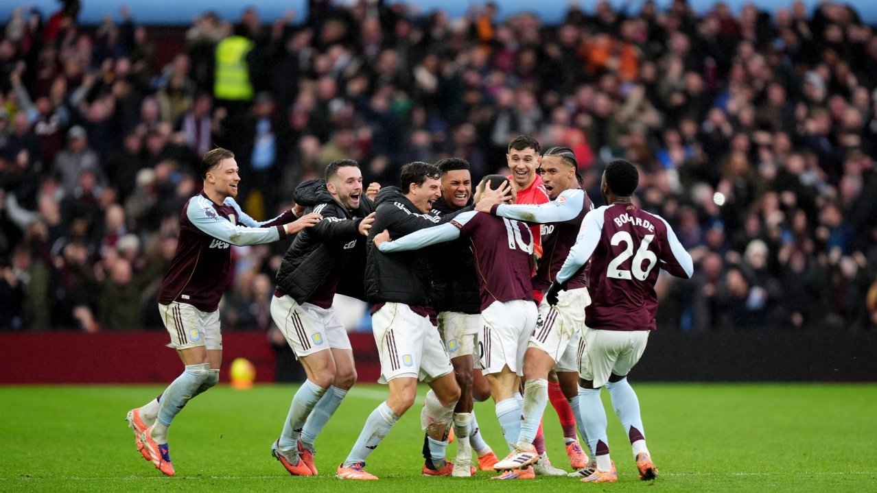Aston Villa's Emi Buendia (fourth right) is mobbed by his team