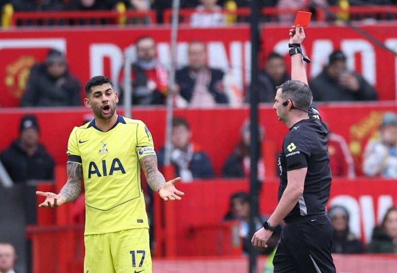 Cristian Romero of Tottenham (L) is shown a red card by Referee Michael Oliver (R) during the English Premier League match between Manchester United and Tottenham Hotspur, in Manchester, Britain, 07 February 2026 (issued 08 February 2026). EPA/ADAM VAUGHAN EDITORIAL USE ONLY. No use with unauthorized audio, video, data, fixture lists, club/league logos, 'live' services or NFTs. Online in-match use limited to 120 images, no video emulation. No use in betting, games or single club/league/player publications.